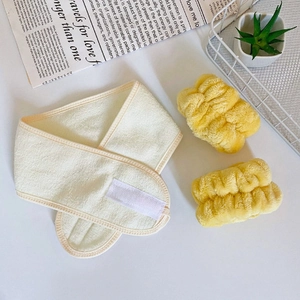Close-up of soft coral fleece headband and wristband set in off-white and bright yellow