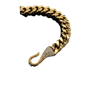 Iced-out Cuban chain bracelet with red-green eye snake head clasp in gold finish
