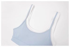 Close-up of contrast layered yoga bra featuring light blue and white ribbed fabric texture