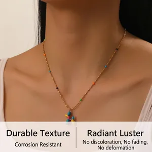Close-up of a colorful balloon dog pendant on a gold bead chain necklace for women