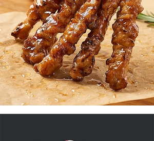Greaseproof sandwich wrapping paper under grilled skewers with rosemary on wood