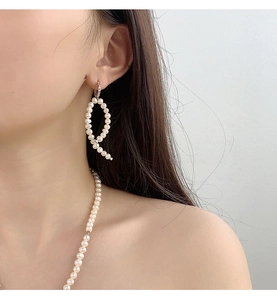 Close-up of S925 sterling silver Baroque pearl earring and necklace set on a female model