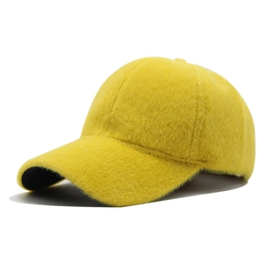 Detail of ginger yellow faux fur texture on a thick warm winter baseball cap