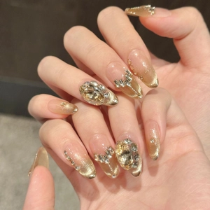Champagne gold cat-eye press-on nails with luxury rhinestones in long almond shape