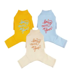 Three warm pet jumpsuits in yellow, blue and beige with 'being nice is fun' printed lettering