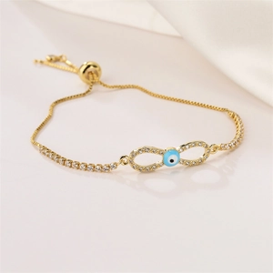 Detail of gold infinity evil eye bolo bracelet with sparkling blue zircon insets