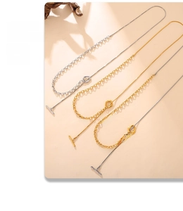 Detail of mixed-link sweater chain with OT toggle clasp in gold and silver finish