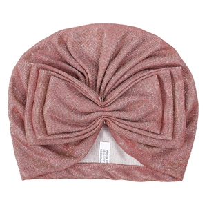 Detail of baby turban hat featuring a large glittery bow in rose gold metallic finish
