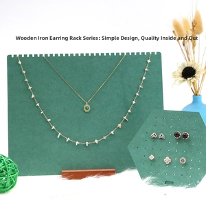 Detail view of green jewelry display stand with necklace and earring holder set
