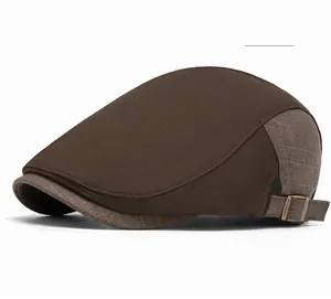 Close-up of vintage brown patchwork newsboy cap with copper adjustable buckle detail