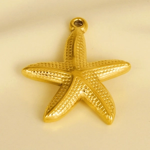 Close-up of golden 304 stainless steel starfish pendant with grainy texture and top ring