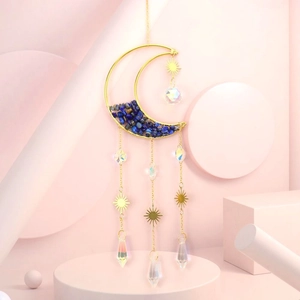 Detail of moon sun catcher with blue crystal chips and colorful prism pendants