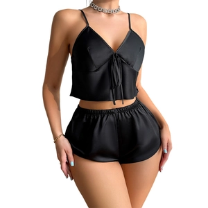 Women's two-piece black satin pajama set featuring a V-neck camisole and matching shorts