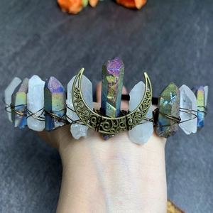 Detail view of crystal bridal crown with blue purple stones and a bronze moon charm