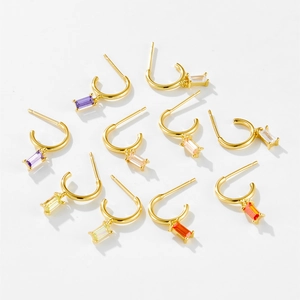 Detail of S925 silver C-shape earrings with colorful baguette-cut gemstones
