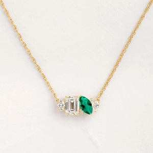Elegant gold necklace with rectangular clear stone and marquise green emerald zircon