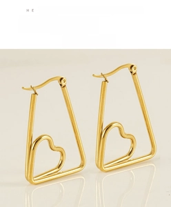 Detailed view of irregular golden heart-shaped hoop earrings with a polished finish