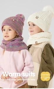Detail of warm winter knit beanie and scarf set for children with fluffy pom-poms