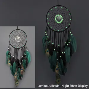 Luminous dream catcher with peacock feathers and glow-in-the-dark beads for wall decor