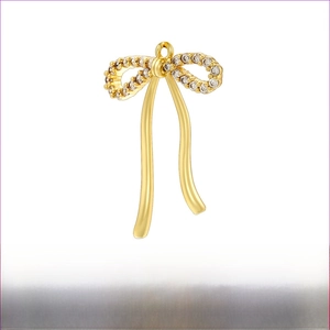 Detailed view of 20x27.5mm gold bow pendant with pearls and cubic zirconia stones