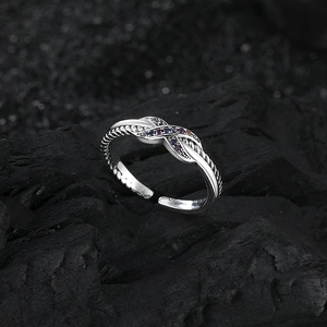 Elegant s925 silver twist knot ring with colorful zircon stones on black charcoal