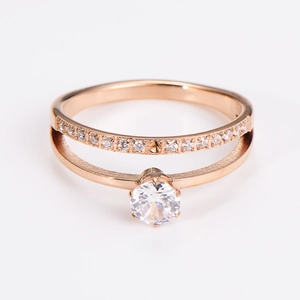 Macro view of rose gold double-layer ring with sparkling zircon solitaire and pavé stones