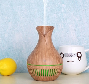 Detail of wood grain aromatherapy humidifier showing ultra-fine ultrasonic mist output