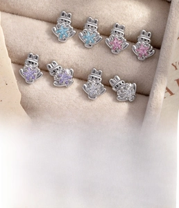 Detailed specs of silver rabbit cartilage piercing with colorful star zircon inlay