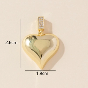 Detailed view of a gold heart pendant with cubic zirconia and size dimensions 2.6x1.9 cm
