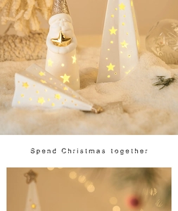 Detail of ceramic Christmas glowing figurines with star cutouts and warm internal light