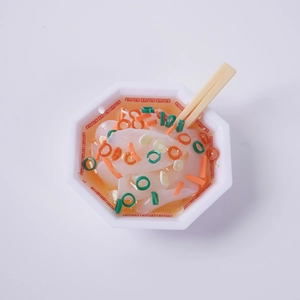 Miniature food keychain with realistic ramen noodle model in white octagonal bowl