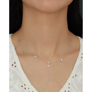 Detail of s925 silver clover pendant necklace with zircon inlay on model's neckline