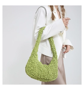 Detail of green popcorn texture fabric on women's lightweight pleated cloud bag