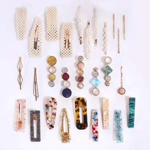 Flat lay view of hair clip set featuring acetate, pearls, and colorful resin accessories