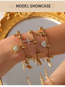 Model wearing gold layered charm bracelet featuring zircon sun, heart and star pendants