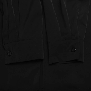 Detail of black shirt cuffs with round buttons and pleated stitching on smooth fabric