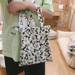 Detail of minimalist floral canvas handbag with black and white flower print pattern