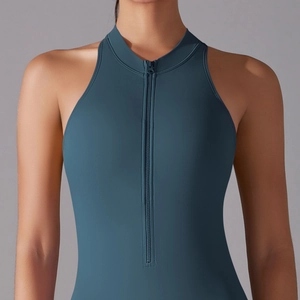 Detail of high-stretch teal yoga jumpsuit featuring front zipper and stand collar