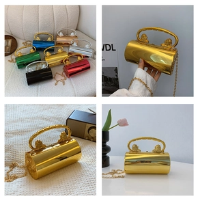 Macro detail of cylindrical metallic evening bag featuring dual lion head top handles