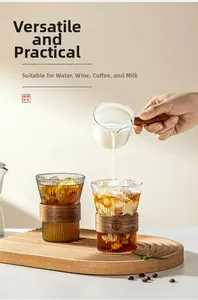 Detailed view of vertical striped glass cups with insulated dark wood sleeves and handle