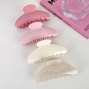 Set of four large acrylic hair claws in pink and beige shades for elegant hairstyles