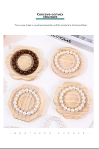 Detail of wooden jewelry display trays in geometric shapes with beads and bracelets