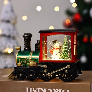 Christmas train snow globe light featuring a snowman and tree in green and red