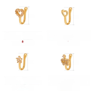 Detail of four golden copper nose cuffs with heart, star, and crown shapes and dimensions