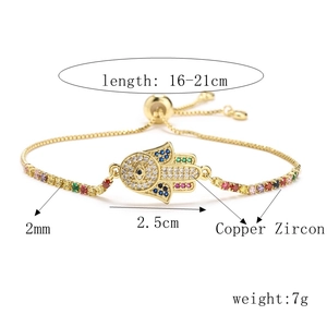 Detailed view of adjustable Hamsa Hand bracelet with colorful zircon stones and gold plating