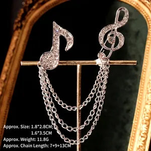 Detail of silver musical note brooches with sparkling rhinestones and layered tassel chains