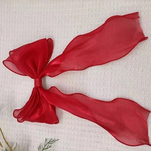 Elegant large red bow hair clip made of shimmering organza fabric for girls