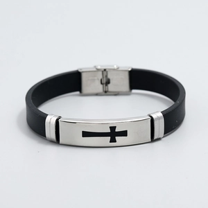 Detail of black silicone bracelet with silver stainless steel plate featuring a cross