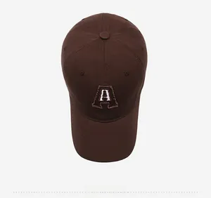 Top view of brown cotton baseball cap with embroidered letter A and vintage raw edges