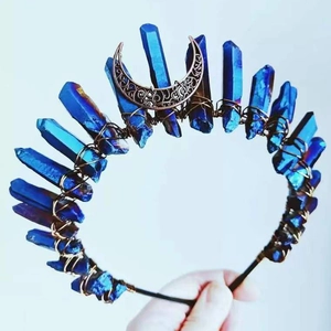 Detailed view of handmade blue quartz crystals and moon charm on a dark wire crown